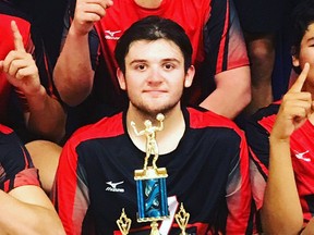 Ben Woodbeck holds a trophy in 2019 when the St. Thomas Aquinas Saints senior boys' volleyball team won a tournament in Steinbach, Man. Woodbeck was named the Saints male senior athlete of the year.