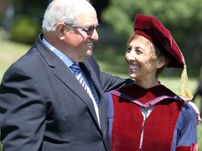 Mario Turco, former director of education of Algoma District School Board, embraces Algoma University president Asima Vezina following her investiture ceremony on Friday, June 8, 2018 in Sault Ste. Marie, Ont. (BRIAN KELLY/THE SAULT STAR/POSTMEDIA NETWORK)