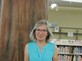 Anne Nothof, a library board member, was announced as this year's winner of the Muriel Abdurahman Volunteer Award. To acknowledge her contribution, Nothof was given a framed print of a painting titled “Volunteer Enchantment.”   Photo Supplied