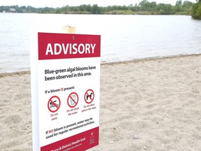 A beach is posted over a possible blue-green algal bloom.
Postmedia File Photo