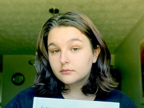 Hailey Brousseau holds up a copy of the 2020 Ecole Secondaire Catholique Algonquin yearbook. An error left one student from the graduating class off its pages, but the book will be reprinted.Submitted Photo