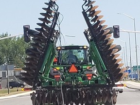 Perth County OPP have charged a tractor driver with operating an overheight vehicle after the tractor pulled down hydro lines in Listowel on July 6. (Submitted photo)