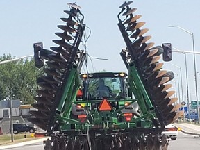 Perth County OPP have charged a tractor driver with operating an overheight vehicle after the tractor pulled down hydro lines in Listowel on July 6. (Submitted photo)