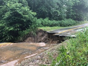 Heavy rain has created a large sinkhole on Norfolk County Road 45 on Saturday. (OPP PHOTO)