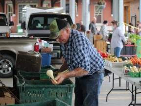 Art Vrolyk prepares produce Saturday at the Petrolia Farmers' Market.