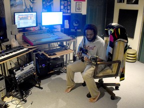 Lyndon John X sits in his Brussels home on July 3 which doubles as his music production area. Daniel Caudle
