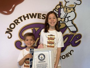 Austin Kurtis, 6, and Ella Kurtis, 11, display a certificate confirming the 530-pound Nanaimo bar they made this past winter as the largest in the world.