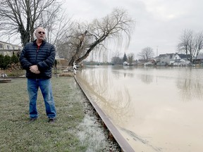 Rob Simpson stands by his Sydenham River seawall earlier this year. On July 9, the St. Clair Region Conservation Authority is warning that record high water levels – that are still rising – on local lakes could create flood and erosion conditions in and around the Wallaceburg region. Jake Romphf photo