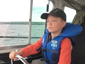 Trent Hare captains the OPP's boat Erskine after helping save his grandfather, who went into medical distress while the two were fishing in a remote area north of North Bay. Supplied Photo