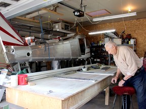 George Minchau of Stony Plain prepares to sit down and work on the plane he is constructing in his garage. A decades-long project for the mechanic, he hopes to give it to someone new to flying in the future.