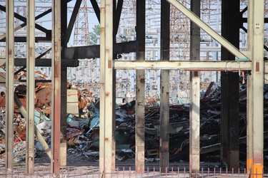 Material left from demolition work at the Lambton Generating Station can been seen through supports of still standing structures where the work has paused.