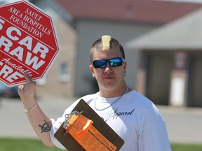 Cole Speers sells tickets for Sault Area Hospital Foundation's Five Car Draw on Great Northern Road in Sault Ste. Marie, Ont., on Saturday, June 20, 2015. (BRIAN KELLY/THE SAULT STAR/POSTMEDIA NETWORK)