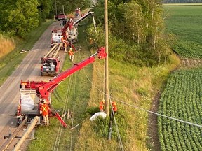 A photo provided by Bluewater Power, via Twitter, shows work Sunday to repair storm damage near Alvinston.