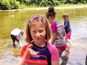 Kids attending the Acorn Adventure Camp at the Five Oaks retreat in Paris learn fascinating facts about aquaculture thanks to the close proximity of the Grand River. Among those discovering the biodiversity of river water is day-camp attendee Abi Leger. – Five Oaks photo