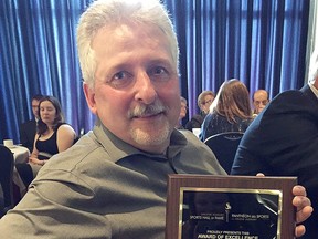 Bob Piche, former director of athletics for Cambrian College, displays his special recognition award at the 2017 Greater Sudbury Sports Hall of Fame awards dinner.