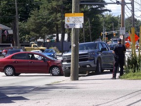 A North Bay Police Service officer attends the scene of a two-vehicle collision, Tuesday afternoon, on Lakeshore Drive just north of Marshall Avenue. Michael Lee/The Nugget