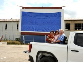 Local filmmaker Craig Thompson, his wife Koi, daughter Jaden, and their dog, LuLu, are parked in front of the new drive-in theatre screen in the Cooper parking lot, where Thompson has organized this year's Movies Under the Stars event. Photo taken in Stratford Ont. July 21, 2020.
Galen Simmons, Stratford Beacon Herald/Postmedia News