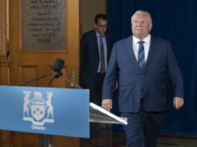 Ontario Premier Doug Ford arrives for the daily briefing at Queen’s Park in Toronto on Friday, July 3, 2020. In the background is Lambton Kent Middlesex MPP Monte McNaughton, who is Ontario's labour minister. CANADIAN PRESS/Frank Gunn
