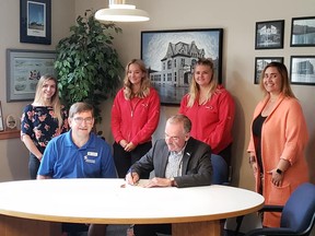 Lifesaving Society Manitoba's flag is flying at Portage la Prairie City Hall to mark National Drowning Prevention Week. Mayor Irvine Ferris (right) and the City's Aquatic Staff joined LSM Media Coordinator Lorne Edwards (front left) in a flag raising ceremony Monday morning. The group went inside City Hall where Mayor Ferris signed a proclamation declaring this National Drowning Prevention Week. (SUPPLIED PHOTO)