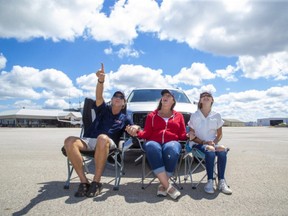 Airshow London chair Jim Graham, wife Charmaine and daughter Madeline show off Airshow London's new Skydrive model at London International Airport on July 13. The two-day September show will see visitors drive onto airport grounds to watch flying displays in socially distanced safety and follow the action on their car radios. Derek Ruttan/Postmedia Network