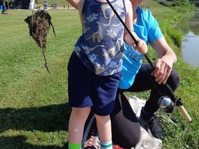 A young angler and his grandmother show off their catch – a clump of mud and grass – during Petrolia’s annual family fishing derby, which took place from July 4-12. Handout/Sarnia This Week
