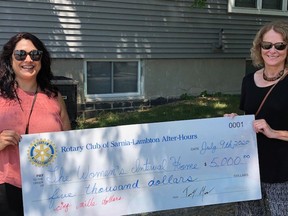 Executive director of the Women’s Interval Home of Sarnia-Lambton Angie Marks (left) accepts a cheque for $5,000 from Rotary Club of Sarnia-Lambton After-Hours’ Francine Hache. The club raised money for the interval home during the month of June. Handout/Sarnia This Week