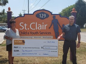 St. Clair Child & Youth executive director Sue Barnes accepts a $10,000 cheque from INEOS Styrolution site director Brian Lucas, money that will be used for a virtual summer camp for children living in at-risk neighbourhoods. Handout/Sarnia This Week