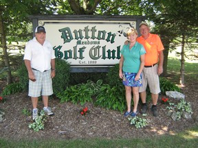 Dutton Meadows Golf Course will be celebrating its 30th anniversary Aug. 3. Shown here are long-time member John McIntyre, left, and owners Judy and Bryan Girard. (Handout/Postmedia Network)