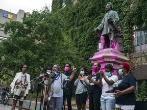 A Black Lives Matter Toronto organizer addresses media in front of the paint-covered statue of Egerton Ryerson at Bond and Gould streets in Toronto last Sunday. Ernest Doroszuk/Postmedia