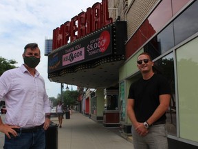 Brian Austin Jr., left, executive director of the Imperial Theatre in Sarnia stands near the marquee with Matt Gordon, director and co-owner of Kel-Gor. The Sarnia company has donated $5,000 to the theatre's fundraising campaign.