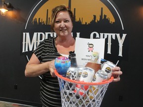 Vanessa Lobodzinski, creator of the Sarnia Ninja Club fundraising campaign stops by Imperial City Brewery to help fill up a basket set for a delivery.