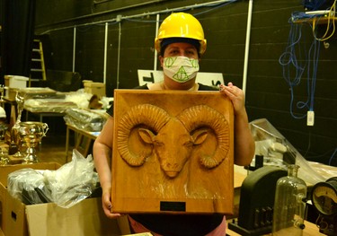 Stratford Perth Archives clerk Shireen Sasani holds a wood carving of the Stratford Central Ram gifted to the school by the graduating class of 1980. Galen Simmons/The Beacon Herald/Postmedia Network