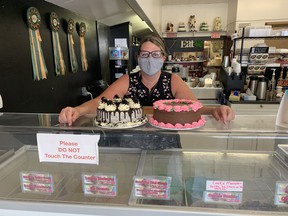 Robin Reitz, owner of Ritzy Cakes and Nifty Gifty in Waterford, says she and her staff have been wearing face coverings for weeks "because we believe we have a responsibility to protect our customers.”