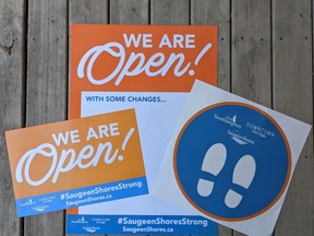 From left are open signs, new practices posters and physical distancing floor decals available for free to Saugeen Shores businesses.
(supplied photo)