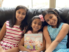 Sarnia sisters, from left, Raveena Duggal, 13, Amisha Duggal, 6, and Diya Duggal, 10, are shown with a copy of their book, Three Bunny Sisters.