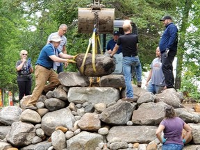 Rotary Club of Portage la Prairie President, Nathan Peto (top right) keeping a watchful eye on all the volunteers helping get the new waterfall up and running at Island Park. (supplied photo)