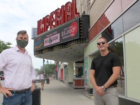 Brian Austin Jr. (left), executive director of the Imperial Theatre in Sarnia, stands near the marquee with Matt Gordon, director and co-owner of Kel-Gor. The Sarnia company has donated $5,000 to the theatre's fundraising campaign. Paul Morden/Postmedia Network
