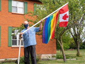 Neil Hubert, manager of administrative support services at Family and Children Services of St. Thomas and Elgin, raises a Pride flag in front of their building. The flag-raising event was one of five taking place in Elgin County, marking the county’s inaugural council-proclaimed Pride Week. Max Martin/Postmedia Network