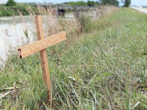 A homemade cross was erected Wednesday, July 29, 2020, near the scene of a deadly crash Monday, July 27, 2020, on Jacob Road in Dover Township, Ont. A seven-year-old girl from Chatham died and her two siblings were injured when a pickup truck landed upside down in a ditch. Mark Malone/Chatham Daily News/Postmedia Network