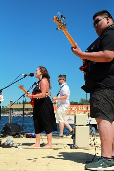 Mike Henry, front, Brooklyn Doran and Cole Zabloski perform on the dock stage at the 12th 'Modified Maybe Annual' Coney Island Music Festival on Sunday, July 26.
