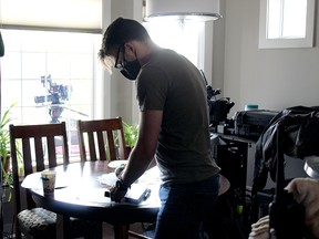 Camera assistant Ben Vanderlinden sets up for a new scene in Connecting Flights Friday in the Town of Stony Plain. The film, which has a $250,000 budget, is one of the first to resume in the province after the shutdowns.