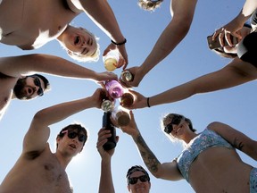 Partiers toast fine summer weather at Anniversary Park in Chestermere, Alta., last Saturday. Public health experts here hope physical distancing and limited gathering are the norm this long weekend. Brendan Miller/Postmedia