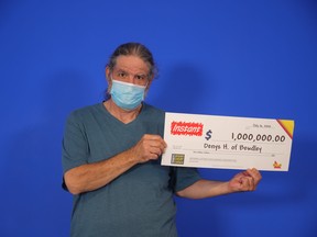 Deny Haynes of Bewdley with his cheque for $1 million after his lottery win.