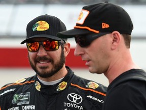 Martin Truex Jr., driver of the #78 Bass Pro Shops/5-hour ENERGY Toyota, and crew chief Cole Pearn talk on the grid prior to the Monster Energy NASCAR Cup Series Bojangles' Southern 500 at Darlington Raceway on September 2, 2018 in Darlington, South Carolina. (Photo by Josh Hedges/Getty Images)