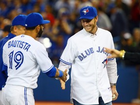 Roy Halladay shakes hands with Jose Bautista before the season opener between the Toronto Blue Jays and the New York Yankees during MLB action at the Rogers Centre in Toronto, Ont. on Friday April 4, 2014. (Postmedia file photo)