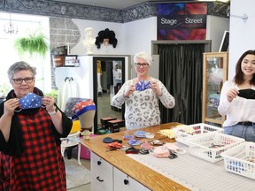 Evelyn Davie, left, of Stage and Street, along wtih daughter Meghan Davie and granddaughter Aurora McDougall, display a selection of non-medical face masks made at the downtown business. JOHN LAPPA/SUDBURY STAR