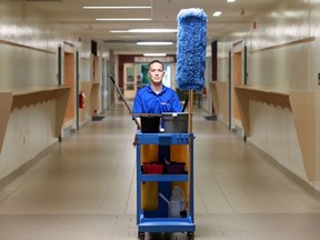 Chief custodian Brian Szabadkay walks the halls at the Kanata Highlands Public School on Friday. The province's plan calls for high-touch surfaces at schools to be cleaned and disinfected twice a day. School boards are scrambling to determine how much that will cost. JULIE OLIVER / Postmedia