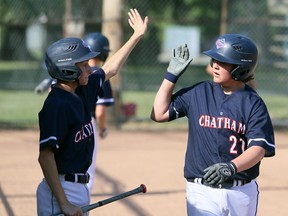 Chatham's Everitt Swayze, right, and Camden Blackburn don't touch hands during a high-five in Game 1 of an exhibition major peewee doubleheader against London at Memorial Park in Blenheim, Ont., on Sunday, July 26, 2020. Handshakes and high-fives are not allowed under Baseball Ontario's new rules during the COVID-19 pandemic. Mark Malone/Chatham Daily News/Postmedia Network