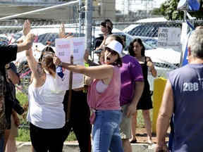 An ag-supporter yells to get a Halton Regional Police constable's attention as tensions flare in front of a stopped transport truck at the entrance of Sofina Fearman's Pork Ltd  (Diana Martin, Ontario Farmer)