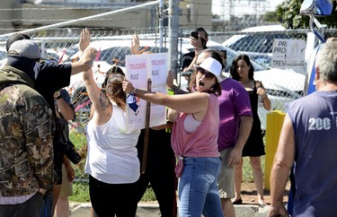 An ag-supporter yells to get a Halton Regional Police constable's attention as tensions flare in front of a stopped transport truck at the entrance of Sofina Fearman's Pork Ltd  (Diana Martin, Ontario Farmer)